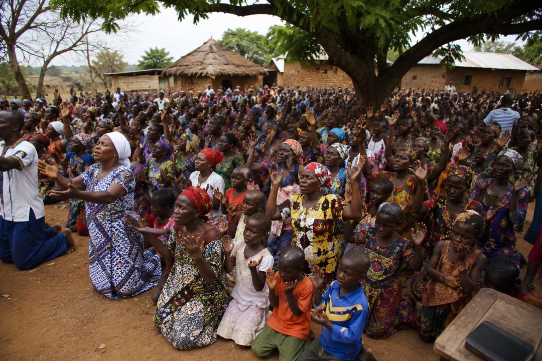 A congregation gathered outdoors for worship